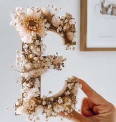 a hand holding up a letter decorated with flowers