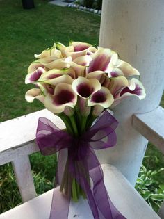 a bouquet of flowers sitting on top of a white chair