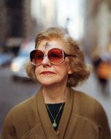 an older woman wearing sunglasses on the street