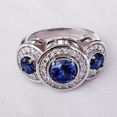 three stone ring with diamonds and blue sapphires