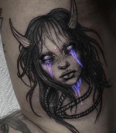 a woman with horns and blue eyes on her thigh