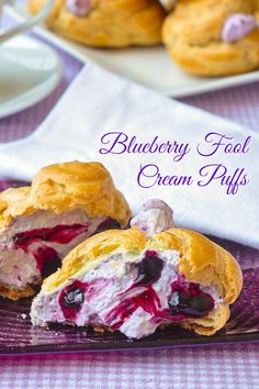 blueberry filled cream puffs on a purple plate