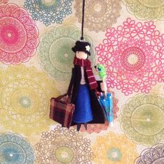 a doll hanging on a wall with luggage