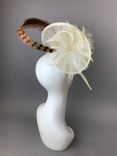 Ivory Fascinator with simple Pheasant Feather. This piece is 0ne size fits all. Please note prior to purchasing that all sales are final. Fascinator includes a hat care card with instructions on how to care for & keep your piece beautiful over time. Looking for a customized piece? Please send me a message and let's create something unique just for you! Don’t forget to follow us on Instagram @TheHatHive British Hats, Ivory Fascinator, Sinamay Fascinator, Womens Tea, Pheasant Feather, Church Hat, Satin Headband, Tea Party Hats, Pheasant Feathers