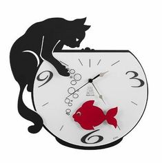 a cat sitting on top of a clock with a fish in it's mouth