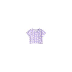 a white and purple polka dot t - shirt sitting on top of a wooden table