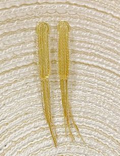 Add an elegant touch to your look with these exquisite tassel drop earrings. The intricate gold and rhodium plating add a luxurious shine to these statement earrings, making them perfect for any occasion. Elevate your style with these exclusive and sophisticated earrings. Made in Colombia. Elegant Metal Jewelry With Tassels, Elegant Metal Tassel Jewelry, Elegant Tassel Dangle Earrings For Pierced Ears, Elegant Dangle Tassel Earrings For Pierced Ears, Elegant Metal Tassel Drop Earrings, Elegant Metal Dangle Tassel Earrings, Elegant Metal Tassel Earrings, Elegant Beaded Tassel Earrings, Elegant Fringe Metal Chandelier Earrings