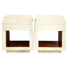 a pair of white nightstands sitting next to each other