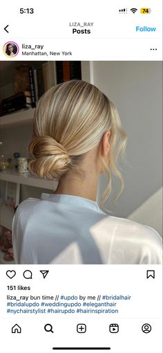 a woman with blonde hair is looking at her twitter account, and she's wearing a white shirt