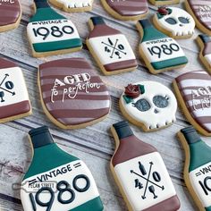 decorated sugar cookies are arranged in the shape of bottles and skull heads with words on them