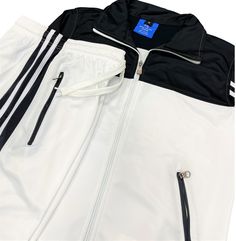 This women 2-piece tracksuit is a great fit for the spring and fall weather in a stylish two color combination outfit with stripes. Tracksuits 2-piece matching sets are a part of everyday life from the GYM the sports field and working from home to daily casual activities. This 2-piece tracksuit (activewear suit) features a seamlessly comfortable track material suitable for any age. The jogger style tracksuit track pants are in line with current fashion trends. About this item 1. Women matching 2-piece activewear tracksuit set Top and bottom outfit 1. Full Zip Up track Jacket with zippered side pockets, stand collar and 2 vertical stripes2. Hemmed jogger track pants with two stripes, zippered side pockets and an elastic waist3. Runs true to size in a comfortable fitting for maximum movement Casual White Track Jacket With Side Stripes, White Sporty Track Jacket With Contrast Stripes, Sporty White Track Jacket With Contrast Stripes, Sporty White Outerwear With Contrast Stripes, White Fall Tracksuit, Sporty Style, White Tracksuit For Sports In Spring, White Spring Tracksuit For Sports, White Spring Sports Tracksuit, Spring White Outerwear With Contrast Stripes