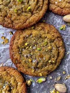 several cookies with nuts and pistachios on top