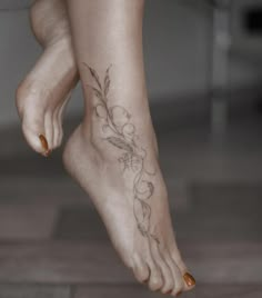 a woman's foot with a flower tattoo on her left side and right leg