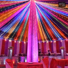 the inside of a tent decorated with bright lights