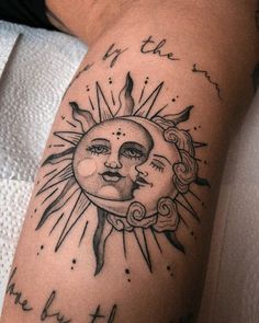 a sun and moon tattoo on the arm