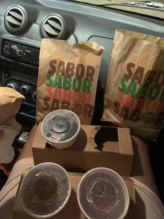 three bags of sabor sit on the dashboard of a car