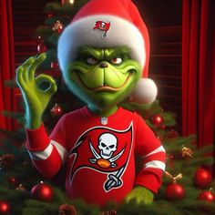 a cartoon character dressed as the tampa football team wearing a santa hat and holding his hand up