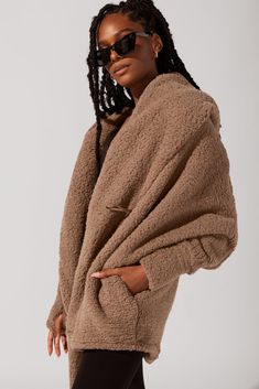 Strut to your morning workout class or down the aisles of Trader Joe’s with our most stylish, oversized Cocoon Coat. This romantic, just-above-the-knee length faux sherpa coat is bound to keep you warm and snug, all cozy-weather season. Our favorite feature: the thumb holes on the sleeves for warmth from head to fingertip. Soft Textured Outerwear For Fall, Cozy Outerwear With Soft Texture And Relaxed Fit, Cozy Relaxed Fit Outerwear With Soft Texture, Comfy Oversized Outerwear With Soft Texture, Oversized Outerwear With Soft Texture For Loungewear, Soft Textured Winter Outerwear For Loungewear, Soft Texture Outerwear For Loungewear, Comfortable Soft Outerwear For Loungewear, Comfy Oversized Winter Outerwear