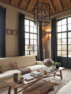 a living room filled with furniture and lots of windows