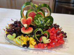 a glass plate filled with fruits and vegetables