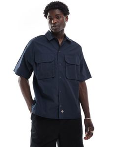 T-Shirt by Dickies No need to keep scrolling Spread collar Snap placket Chest pockets Regular fit Casual Camp Shirt With Patch Pockets, Casual Short Sleeve Camp Shirt With Patch Pockets, Casual Blue Tops With Flap Pockets, Casual Short Sleeve Shirt With Patch Pockets, Blue T-shirt With Pockets And Short Sleeves, Casual Short-sleeved Shirt With Patch Pockets, Blue Short Sleeve Tops With Pockets, Utility Style Short Sleeve Relaxed Fit Shirt, Relaxed Fit Workwear T-shirt With Pockets