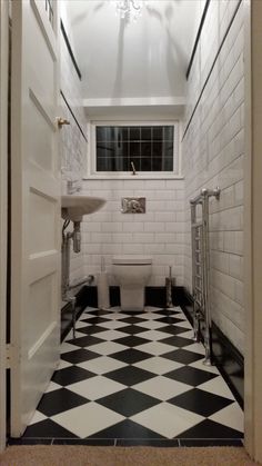 a bathroom with black and white checkered flooring