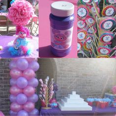 there are many different items on the table and in the background is a cake, cupcakes, flowers, and other decorations