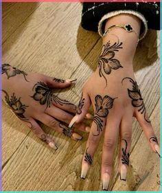 two hands with tattoos on them, one is holding the other's hand and the other