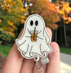 Our Fall ghost badge reel would make a perfect gift for nursing and hospital staff, doctors, students, teachers, child care providers, office workers, and anyone who adorns keys, identification, or swipe cards. Or treat yourself! The Ghost badge reel  is created from acrylic material and affixed to a round retractable reel which is extendable to 34" for ease of card swiping, and snapping back into place immediately upon releasing your card. The reel itself is attached to a either a standard clothing clip (which you can clamp on your scrubs, collar, belt, or just about any other material), or a slide on pocket/belt clip, which are both available in the options section of this listing.  We love custom orders and if you have a specific variation or design in mind, then please send me a messag Fun White Badge Reel For Personal Use, Funny White Badge Reel For Gift, Nurse Vibes, Card Swiping, Fall Ghost, Halloween Badge Reel, Cna Nurse, Swipe Card, Vet Clinic