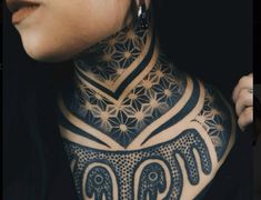 a woman with an elephant tattoo on her neck