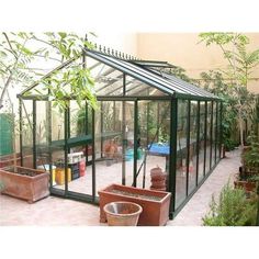 a green house with potted plants in it