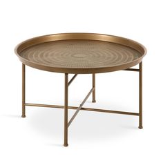 a round metal table with an intricate design on the top and bottom, against a white background