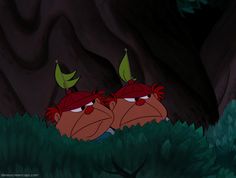 two cartoon characters sitting in the grass with their heads turned to look like they are looking at each other