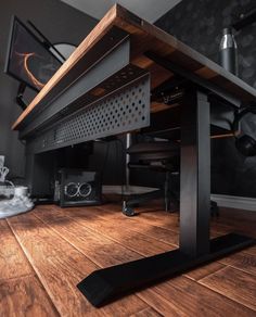 a computer desk sitting on top of a wooden floor