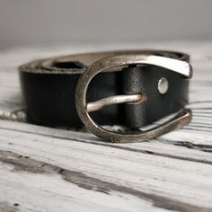 Add a touch of Scandinavian charm to your wardrobe with this Vintage Swedish leather belt! This unisex belt in classic black color is both stylish and versatile, perfect for adding a timeless accessory to any outfit. Sized at 85, it's ideal for wearing with jeans or cinching in a dress for a flattering silhouette. Crafted with quality leather, this belt is sure to become a wardrobe staple for years to come. Elevate your look with this vintage piece that exudes both style and heritage. Vintage go Classic Black Belt Buckle, Classic Black Belt Buckles With Silver Buckle, Classic Adjustable Black Belt Buckle, Black Adjustable Belt With Silver Buckle, Adjustable Black Belts With Silver Buckle, Adjustable Black Belt With Silver Buckle, Classic Black Belt With Leather Strap, Modern Black Belt Buckles For Everyday, Everyday Black Leather Belt Buckles