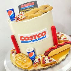 a cake made to look like a bucket full of hotdogs and buns