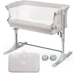 a white baby crib next to an infant changing table and diaper bag on a white background