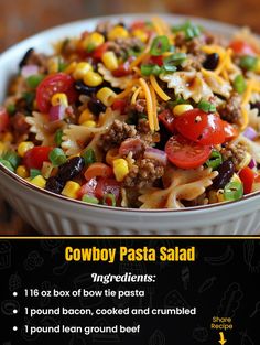 a bowl filled with pasta and vegetables on top of a wooden table next to a menu