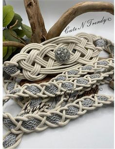 the white rope is tied together with silver beads