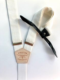 We are releasing the first of our formal “Black Tie” Suspenders / Braces with monochromatic black leather Back patch and black leather button on attachments. Gold colored brass hardware available upon request.All Stratton Suspender strap sets can be used with our vintage leather button on attachments or with our MOST popular, beautiful yet shockingly functional, leather clasp sets. A truly unique way to stand out with class! Guaranteed to not come off. More than that, the modularity of Stratton Linen Set, Back Patch, Brass Hardware, Suspenders, Black Tie, Braces, Vintage Leather, Gold Color, White And Black