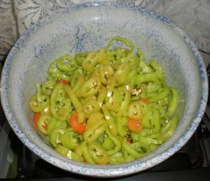 a blue bowl filled with vegetables on top of a stove