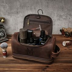 Personalized Men's Leather Toiletry Bag, Groomsmen Gifts, Engraved Dopp Kit, Gift for Him, Travel Toiletry Bag, Men's Leather Accessory Our Laser Engraved Full Grain Leather Toiletry Bag is the perfect gift for anyone who enjoys a minimalist aesthetic or for any occasion such as graduations, birthdays, Father's Day, weddings, groom's suites, or any other occasion. This toiletry bag has two main compartments and a bottom compartment with ten elastic straps and a mesh pocket to keep your travel to Brown Bags With Engraved Logo For Daily Use, Brown Travel Bags With Engraved Logo, Brown Leather Bags With Engraved Logo, Mens Toiletries, Mens Toiletry Bag List, Men's Toiletry Bag Pattern, Men’s Toilette Bag, Men Leather Toiletry Bag, Coffee Canvas