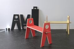 three different types of wooden furniture in a room with white walls and black flooring