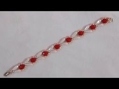 a bracelet with red glass beads on it