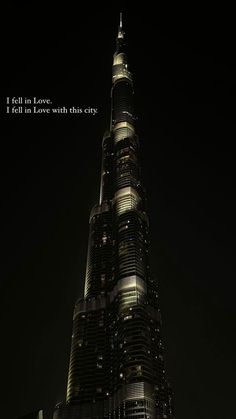 the burj building is lit up at night with a quote written on it