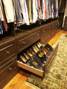 an open drawer in a closet filled with shoes