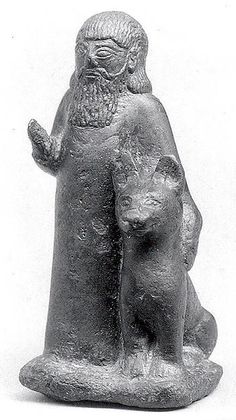 an old statue of a man with a cat on his lap, possibly from the early century