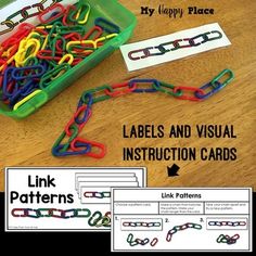 a box filled with lots of different colored paper chains on top of a wooden table