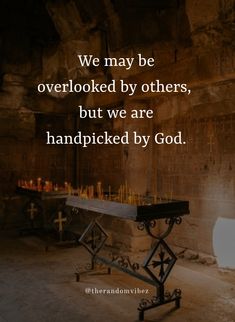 a table with candles on it in front of a stone wall and the words we may be overlooked by others, but we are handpicked by god