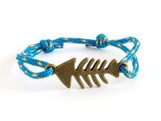 "* Fish Bracelet Welcome to Nadamlada! https://ChalkBagsNadamlada.etsy.com/ Looking for fish bracelet, that will fits everyone? This fish jewelry men is nice for him and for her. It is adjustable. Nadamlada's fish friendship bracelet is nice in fisherman gift ideas, or just as a birthday gift for men or for women who loves fishing, sailing, swimming, etc. We handmade it as a rope bracelet with a fish bone jewellery charm. The metal charm is zinc alloy in silver or brass colors. The rope is tiny Fish Friendship Bracelet, Navy Bracelet, Skeleton Bracelet, Skeleton Jewelry, Dad Bracelet, Fish Bracelet, Navy Jewelry, Fish Skeleton, Sailor Knots